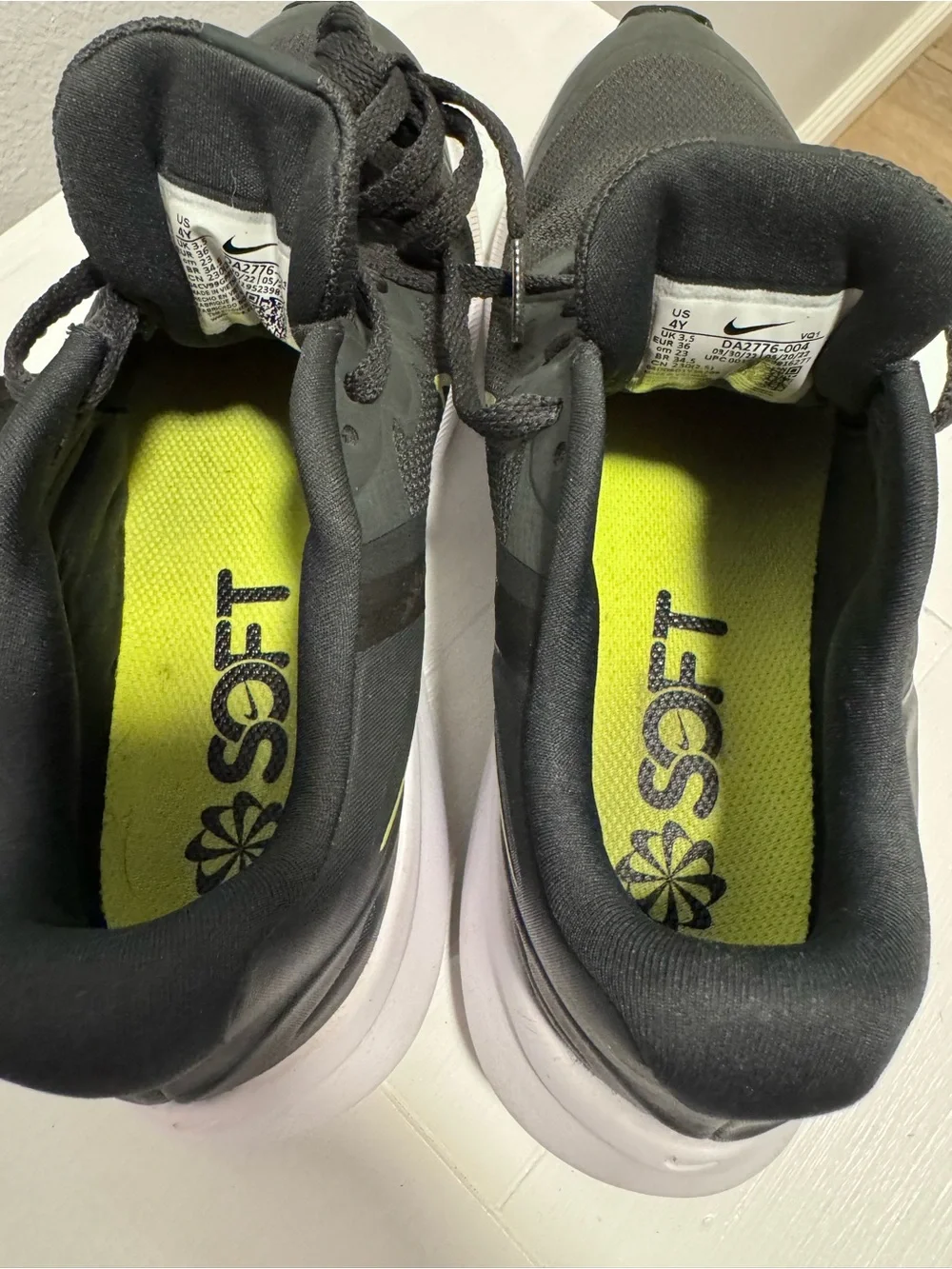 Nike Black Sneakers with Neon Yellow Swoosh and White Sole
